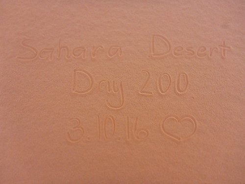 "200 Days" written in sand